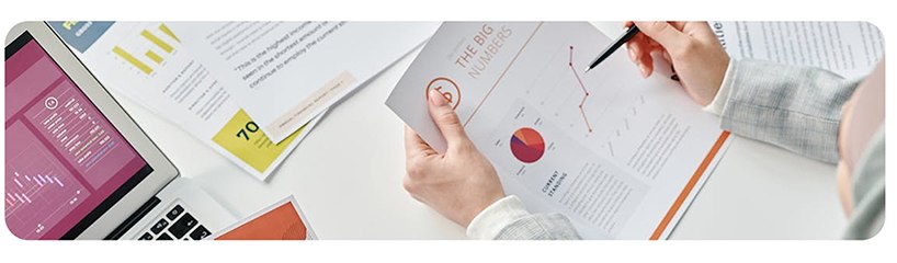 Financial reports and charts reviewed at a desk